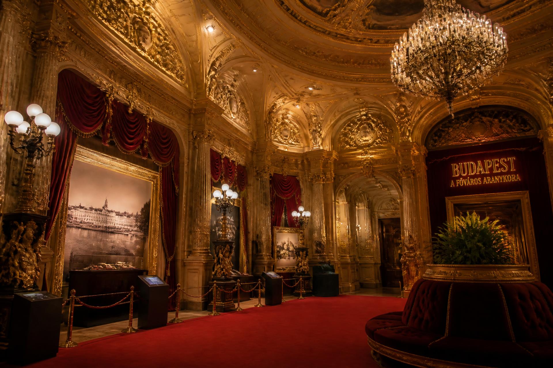 Gilded exhibition interior with red carpet atmosphere
